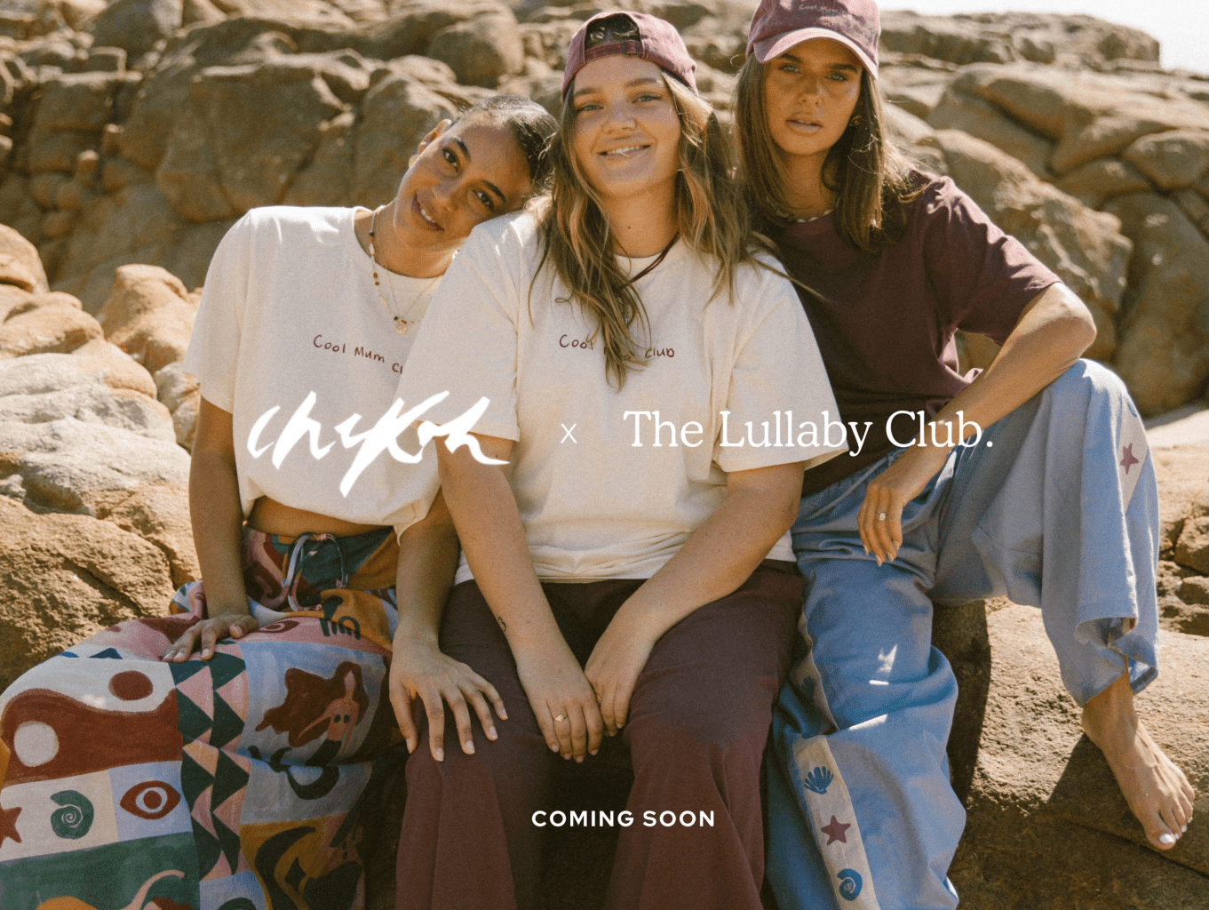 Three women wearing linen printed sets, relaxed sitting on stairs outside in a fashionable manner
