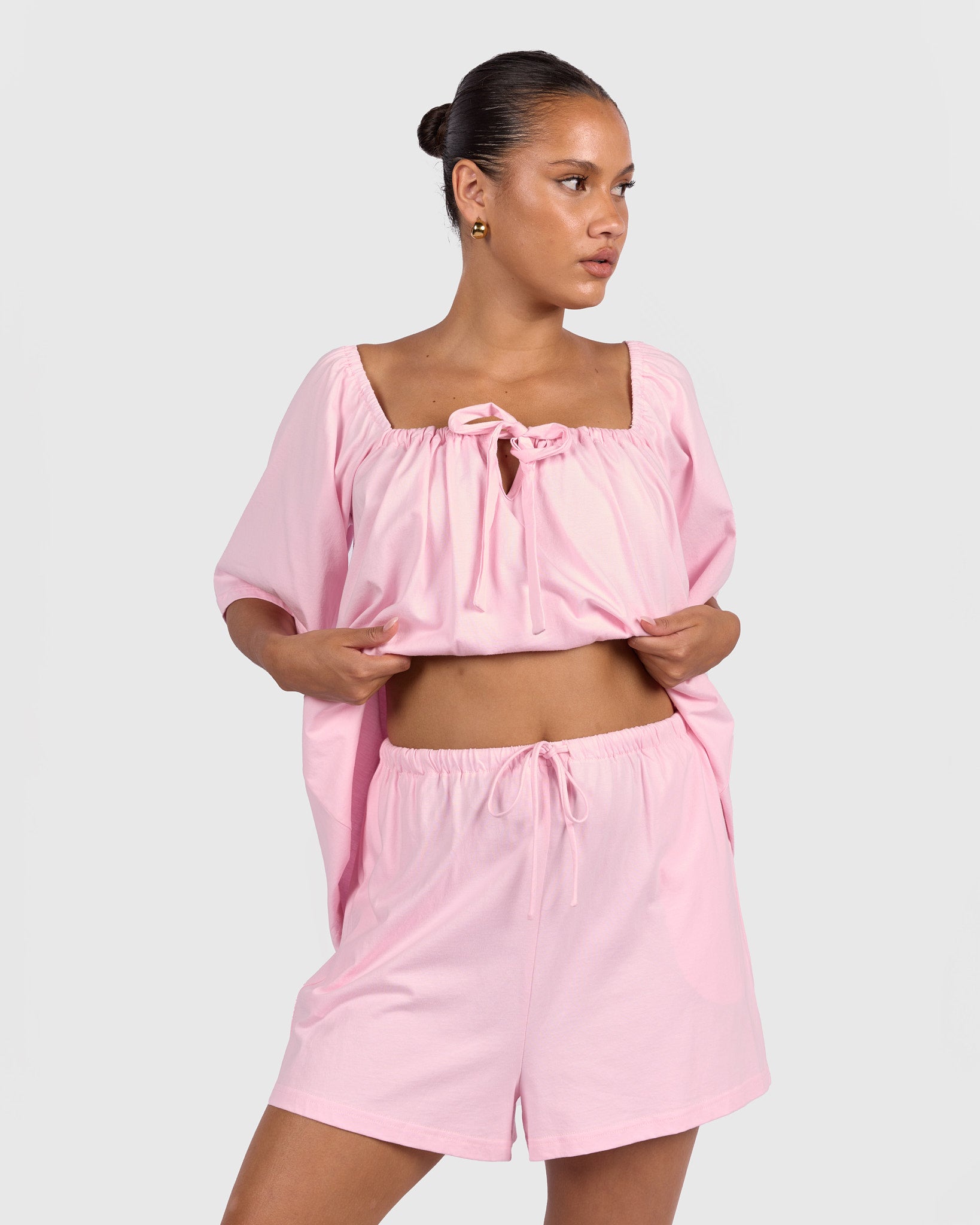 Woman wearing breastfeeding and bump friendly pj top