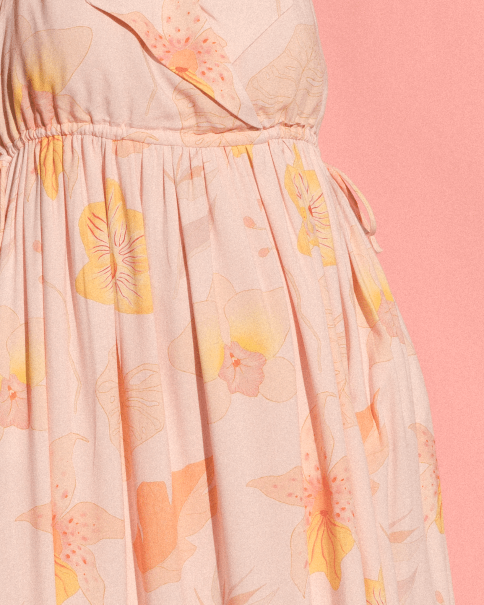 Woman wearing light pink floral bump-friendly maxi dress