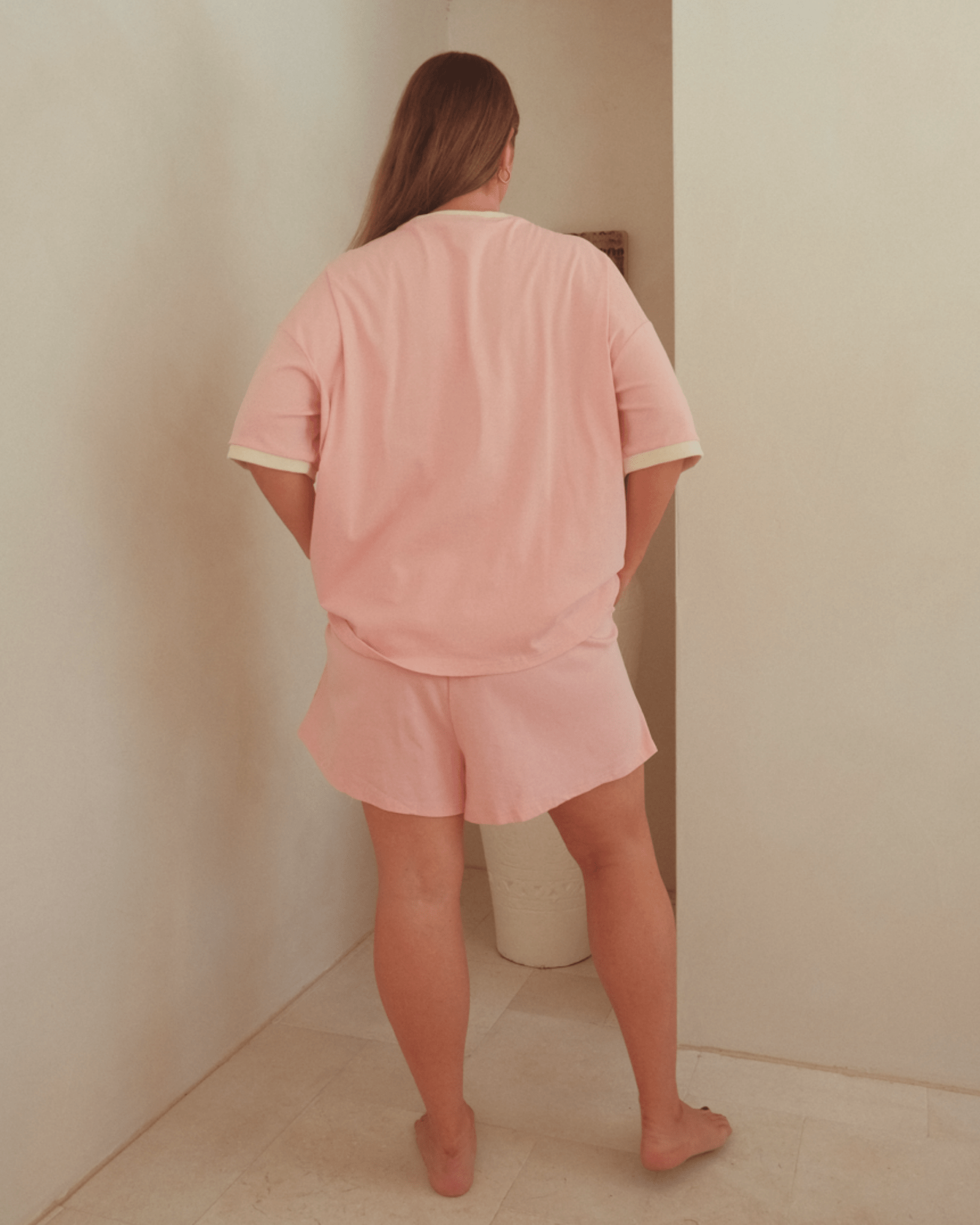 Woman wearing summer pink loungewear set.