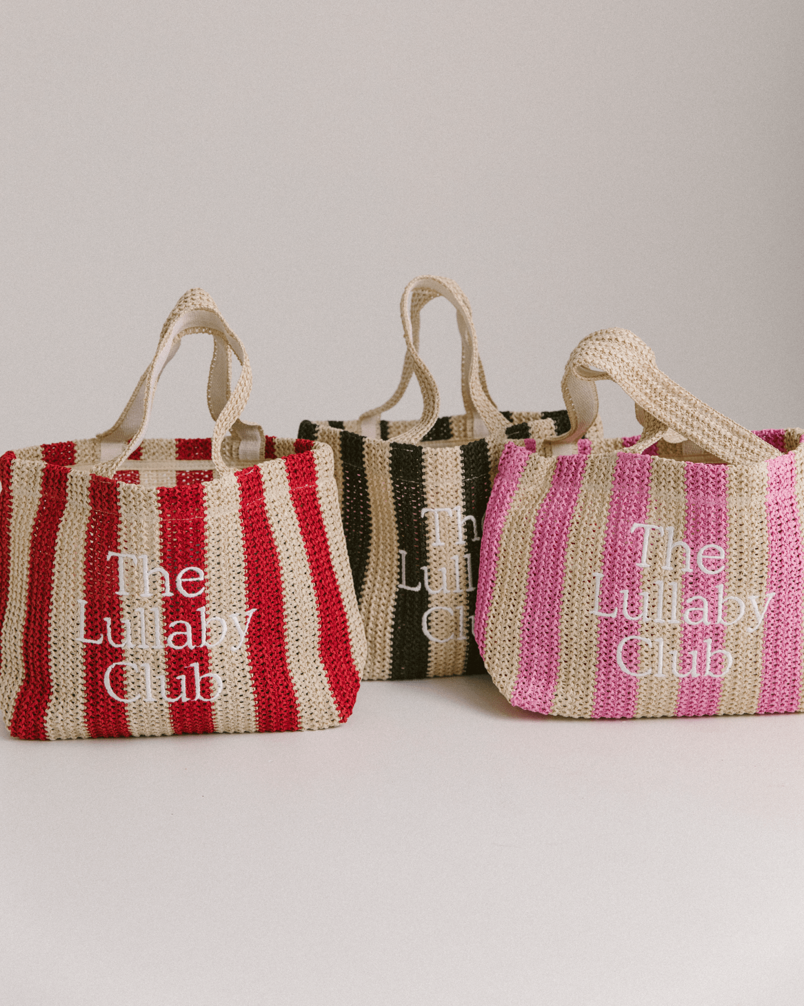 3 striped Raffia tote bags in red, black & pink colourways.