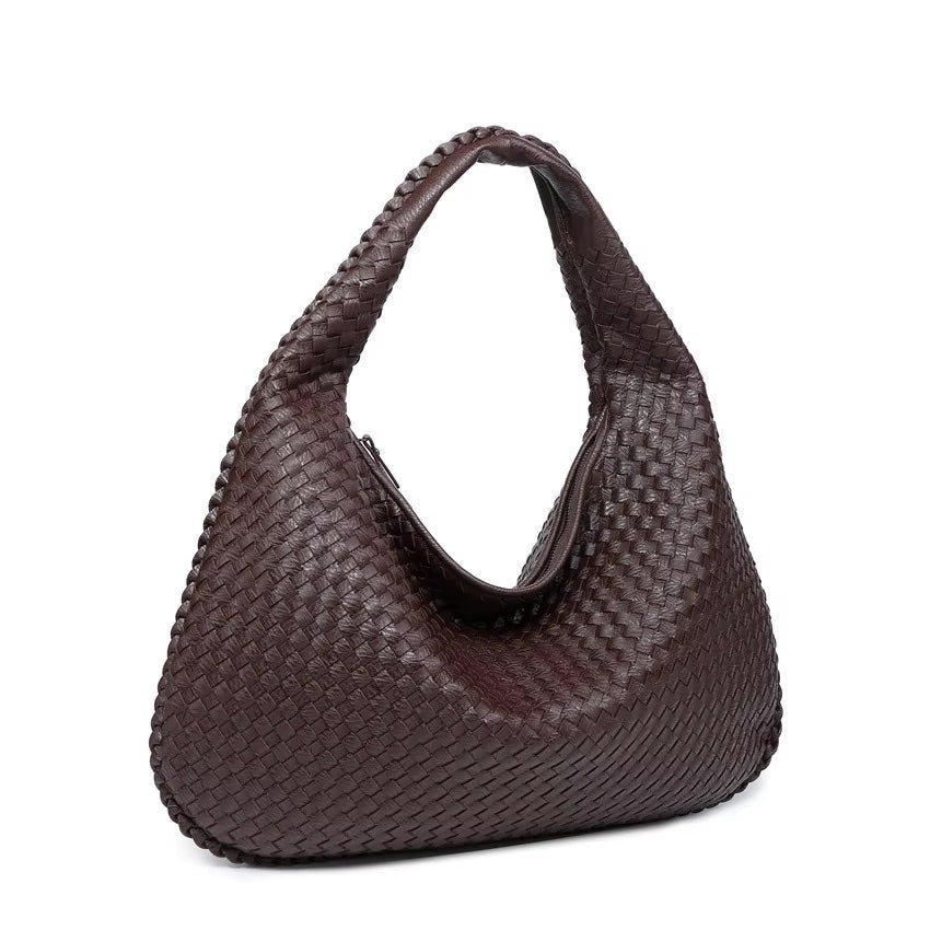 Brown woven handbag on a white background
