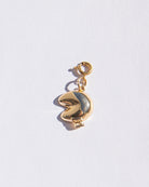 Gold charm with a fortune cookie pendant on a white background