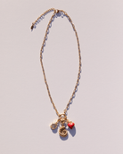 Adjustable gold link charm necklace with gold charms attached.