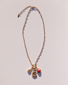 Gold plated chain link necklace with a range of charms attached
