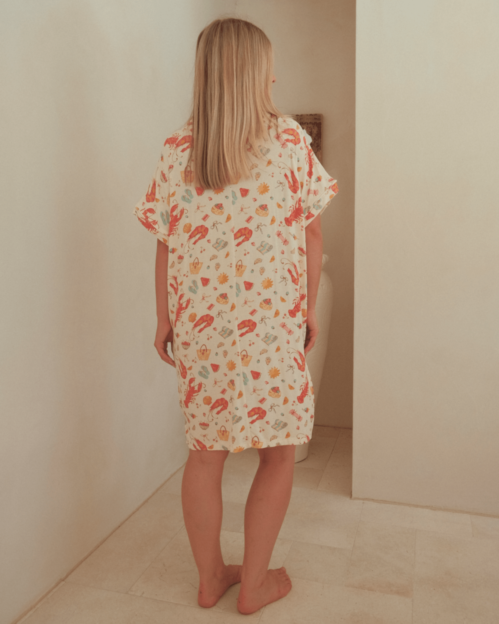 Woman wearing an oversized nightgown in a lightweight and breathable fabric.