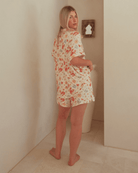 Woman wearing summer breathable pj's in a christmas print.