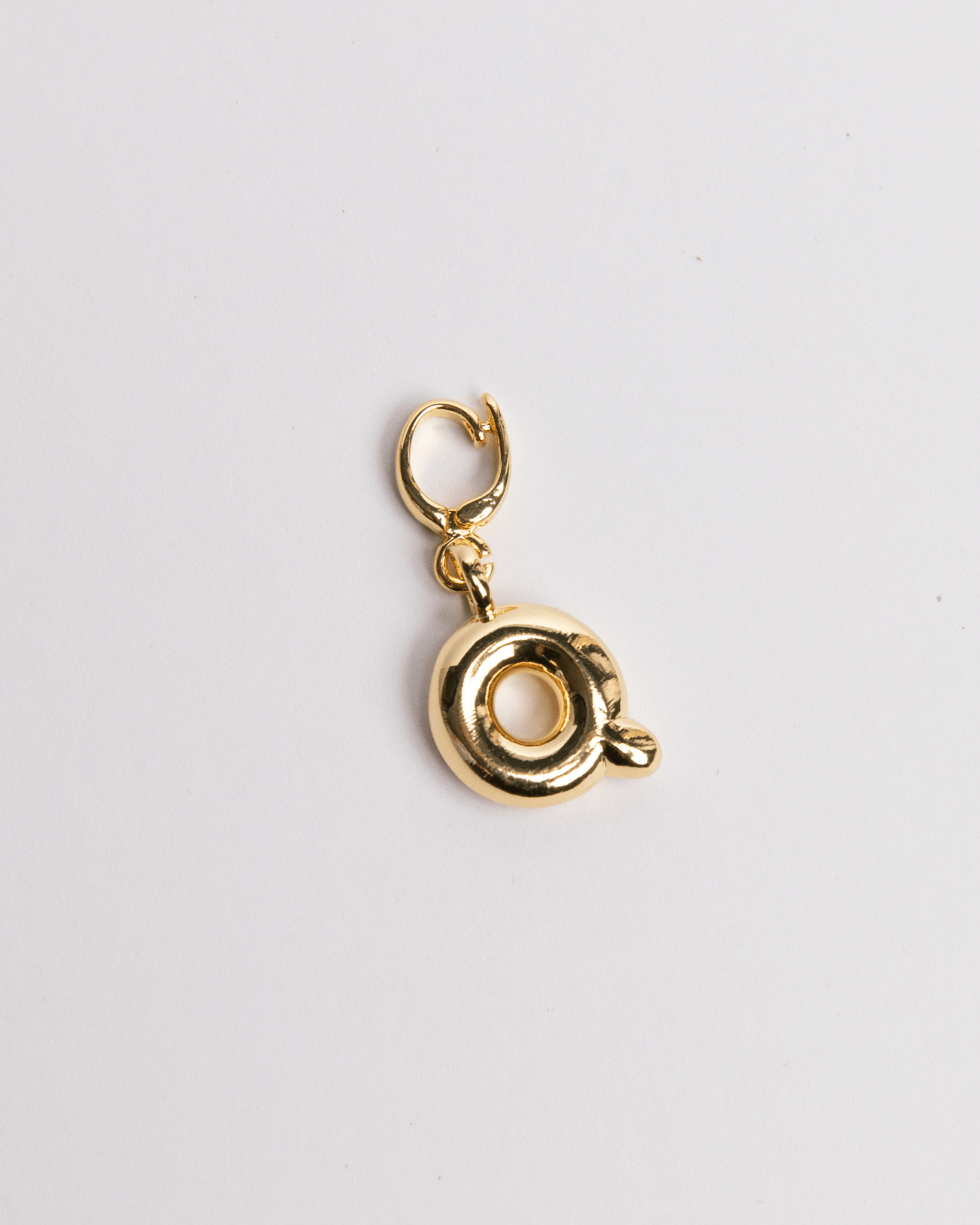 Gold Q letter charm for a charm bracelet or necklace in a stylized bubble design.