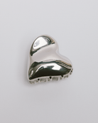 Silver wavy heart shaped hair clip accessory. 